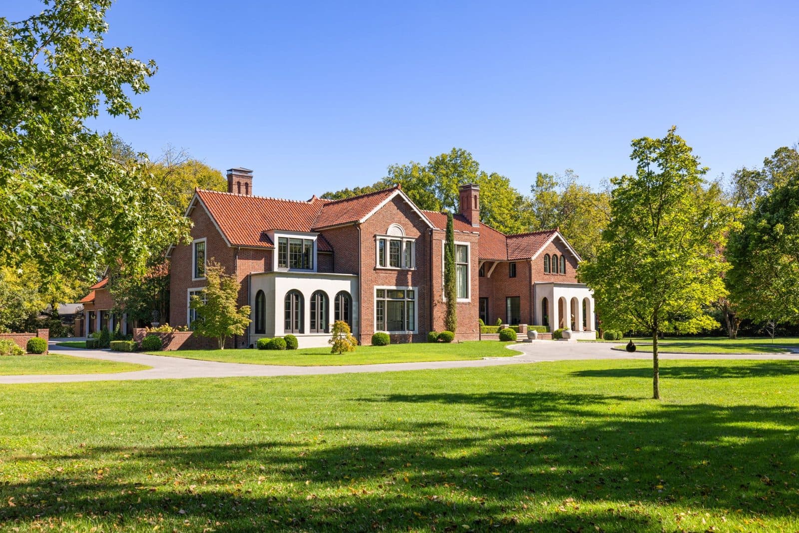 Front exterior of the brick house with a clay tile roof at 4316 Franklin Pike, one of the Oak Hill homes for sale in Oak Hill Nashville